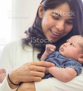 Woman holding a baby.